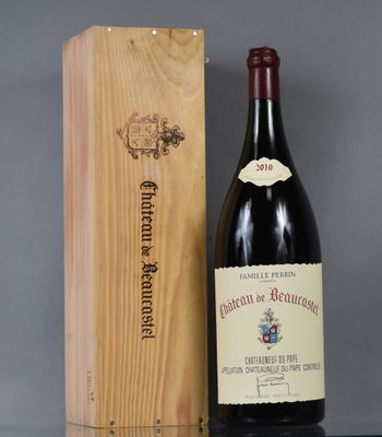 the bottle of wine is sitting next to the wooden box