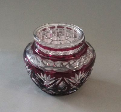 a small glass jar with a lid sitting on a table