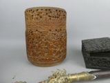 a wooden box, a knife, and a box on a table