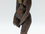 sculpture of a woman holding a baby on a wooden base