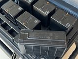 four batteries in a case on a white table
