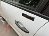 a white car with a clock on the side of it