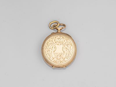 a close up of a gold pocket watch on a white surface
