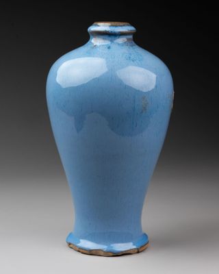 a blue vase that is sitting on a table