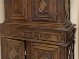 a wooden cabinet that is in the corner of a room
