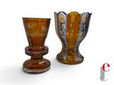 two vases sitting next to each other on a white surface