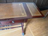 a small table with a book on it on a hard wood floor