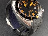 a watch that is sitting on a black surface