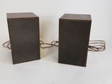 pair of vintage speakers with cord on white background