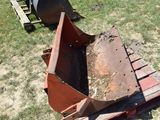 a tractor that is sitting in the grass next to a bulldozer
