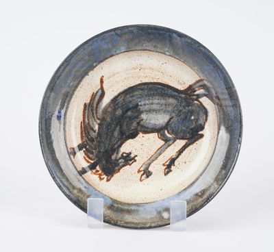 a plate with a picture of a goat on it