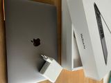 a box with an apple laptop and a charger on the table