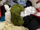 a pile of clothes that is sitting on the floor