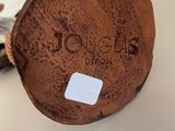 a brown object on the table with a tag on it