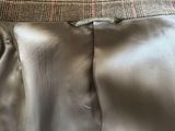 the back of a dress with a tie on it sitting on a bed