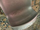 a metal chair that is sitting on a tiled floor