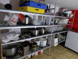many pots and pans on the shelves in the kitchen