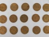 a close up of a bunch of coins on a white surface