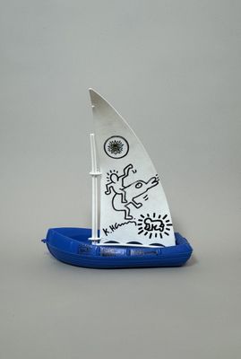 a small sailboat with a drawing on the side of it