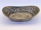 an antique silver plate with a decorative design on it