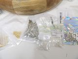 a wooden bowl that has many different types of screws in it