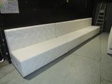 a white couch that is in a room with a ladder