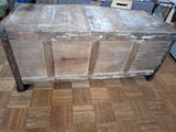 an old wooden chest sitting on a hard wood floor