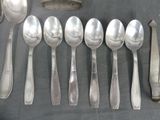 a lot of silver spoons and spoons on a table