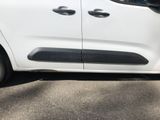 a small white van parked on the side of the road