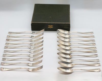 a lot of forks sitting on a table next to a box