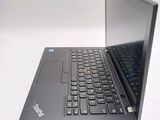 a laptop computer sitting on a table with a keyboard