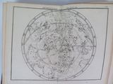 an open book with a drawing of a star map on it