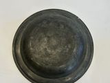 a metal bowl sitting on top of a white table