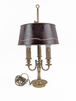 brass plated table lamp with a black shade and a cord