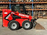 a picture of a red ski - loader parked in a warehouse