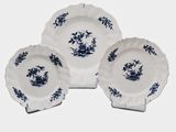 three blue and white plates with blue flowers on them on a white surface