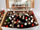 many bottles of alcohol in a box on the table