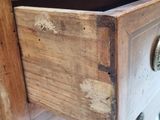a close up of a wooden drawer with a metal knob