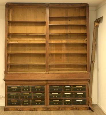 a large wooden bookcase with many drawers in it