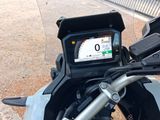 a close up of a motorcycle with a gps device on the handlebar