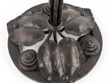 a metal umbrella with leaves on it on a white background