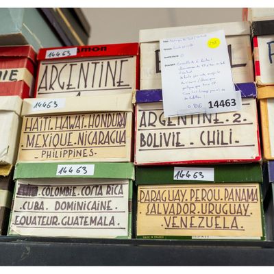 several boxes of books stacked on top of each other on a table