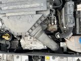 a close up of a car engine with the hood open