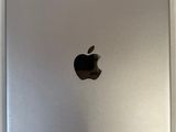 an apple ipad sitting on top of a table next to a white wall