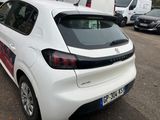 a white car parked in a parking lot with other cars