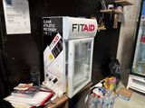 a refrigerator that is sitting on a table in a room