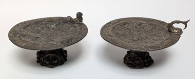 two metal trays that are sitting on a table