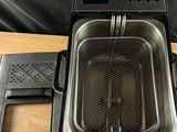 a small fryer sitting on top of a wooden table