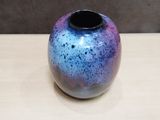 a blue and purple vase sitting on a table