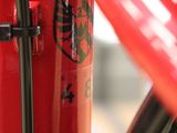 a close up of a red bicycle with a qr code sticker on it